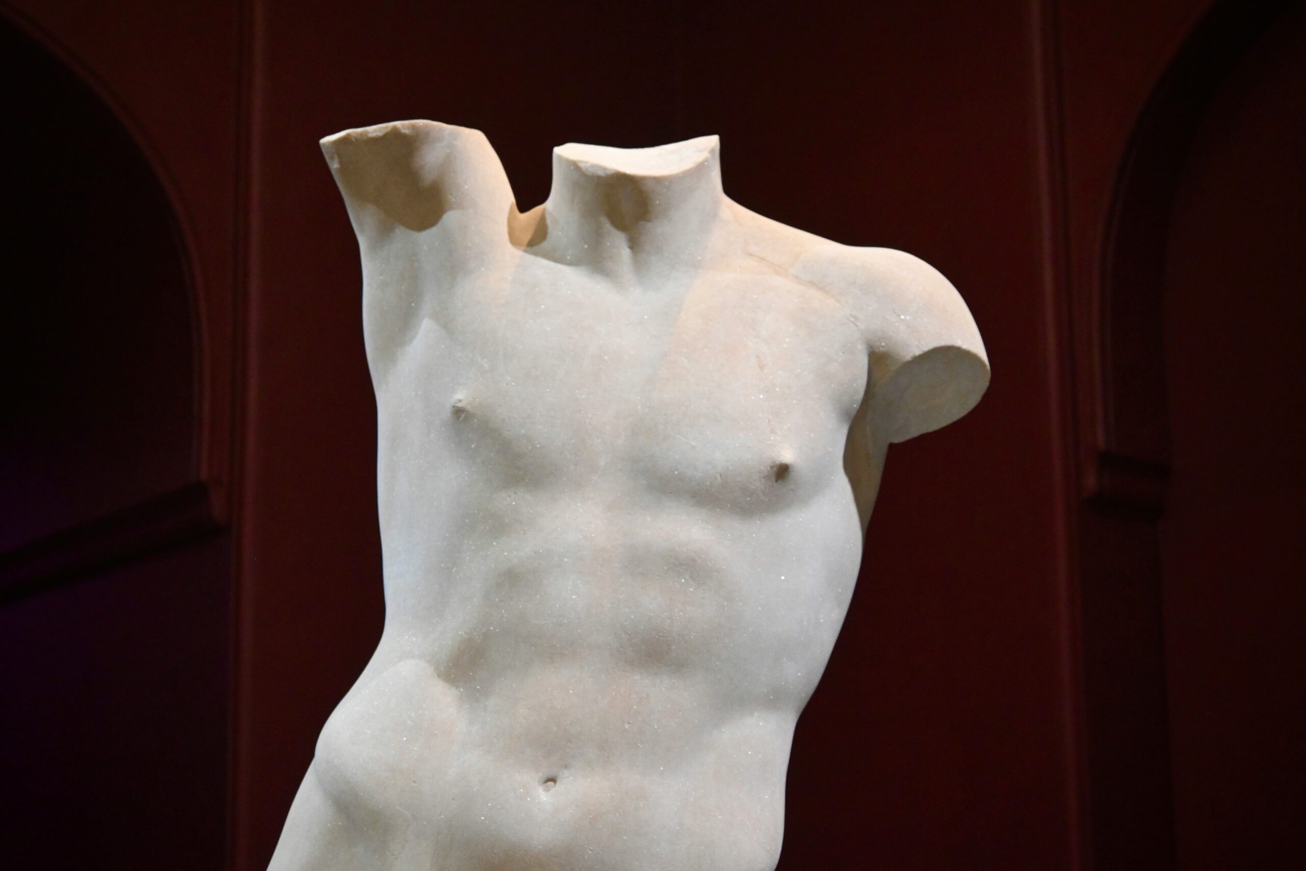 Classical marble statue of a male torso – symbolising idealised male bodies and the pressure men face around body image and self-esteem