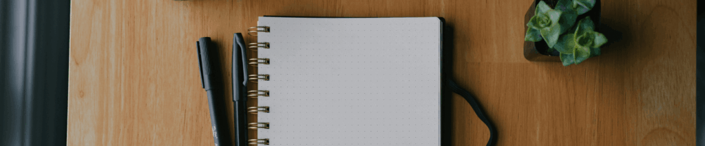 A blank notebook and pen