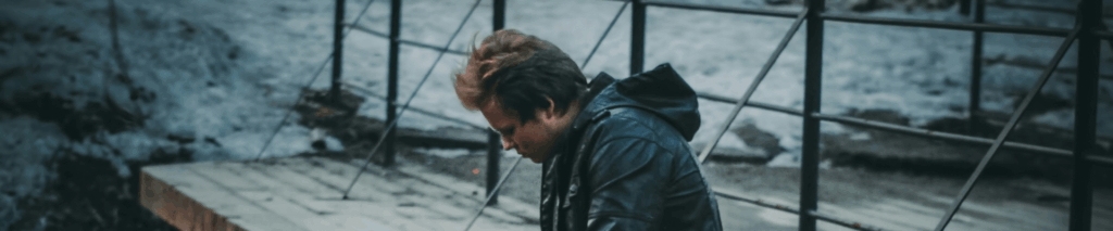 A man seated head down, symbolising struggles with men's mental illness