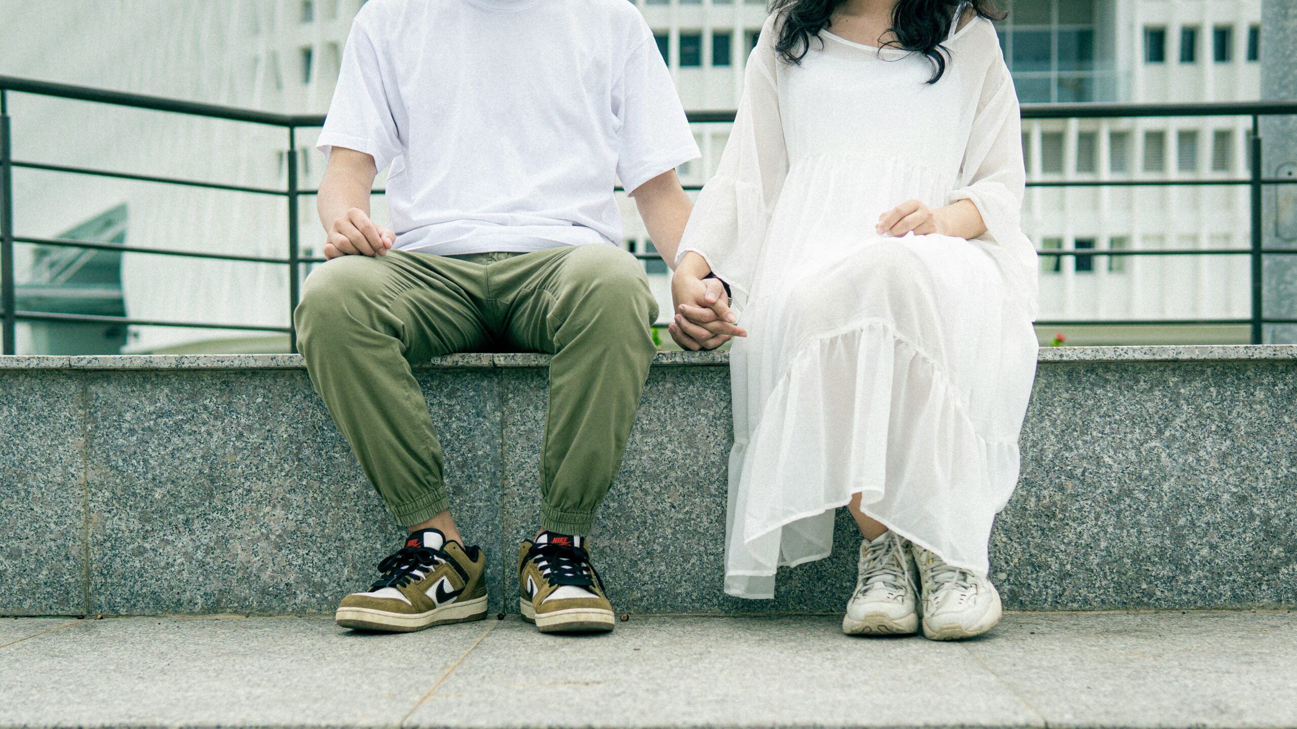 A couple sitting together holding hands