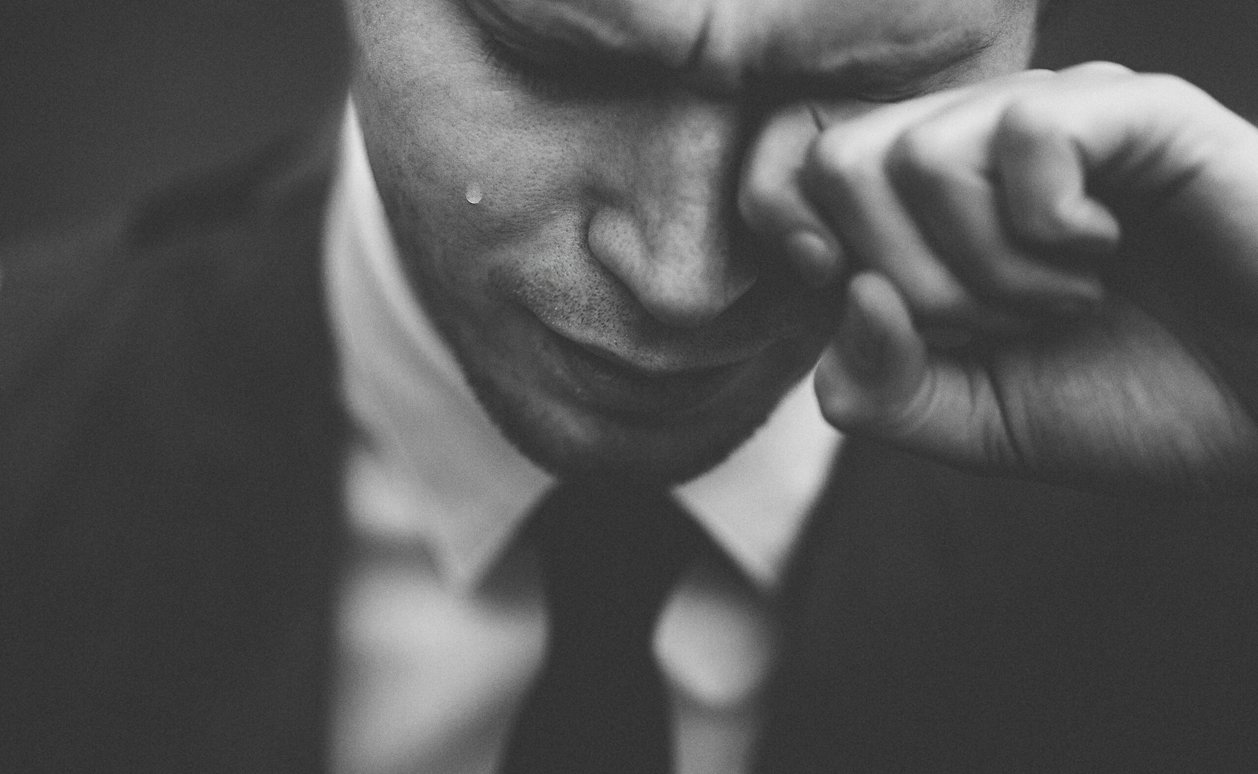 A man crying to highlight the strains of men showing emotional vulnerability