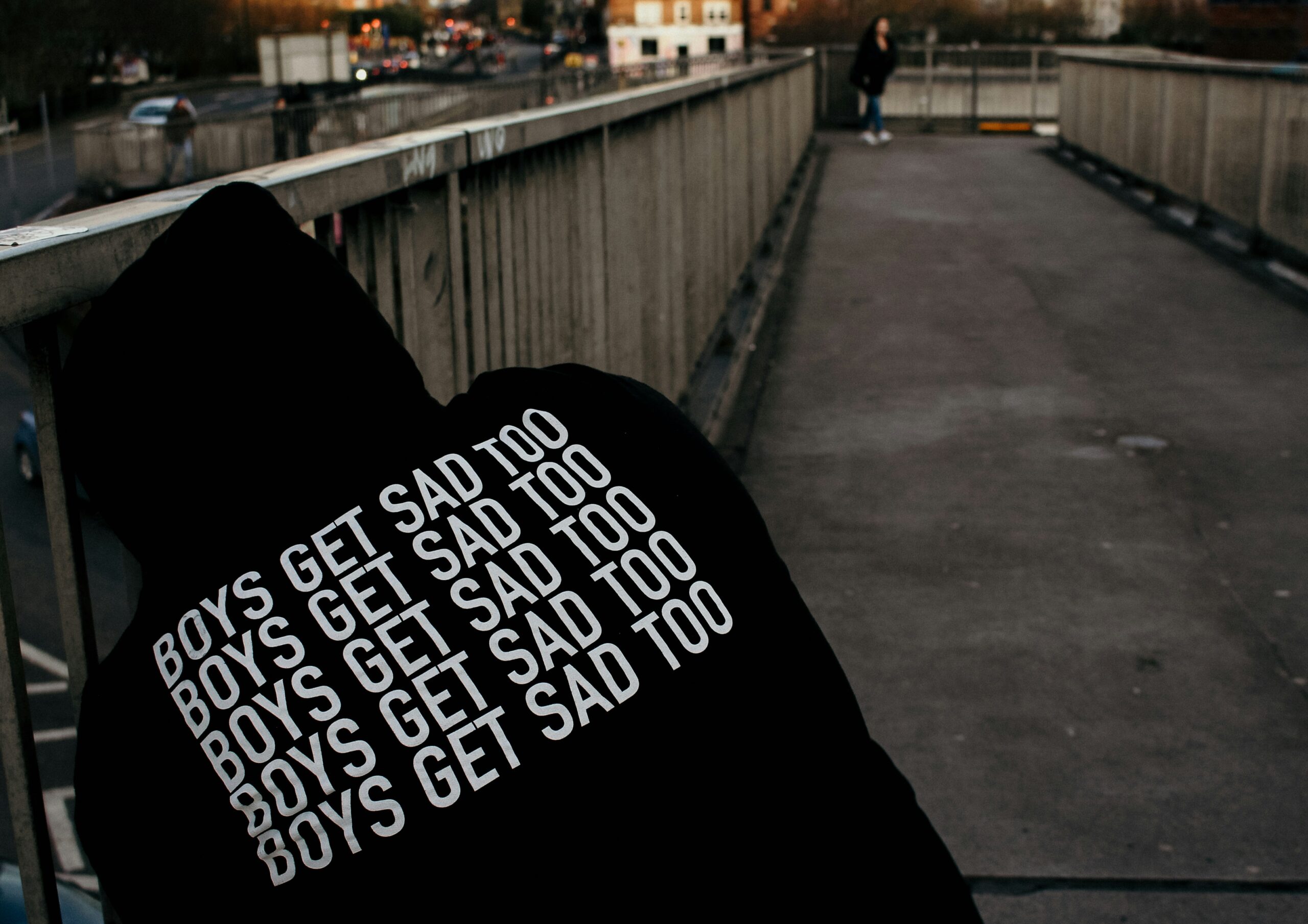 A man wearing a hoodie saying 'boys get sad too' - outlining why men also need support for their mental health.